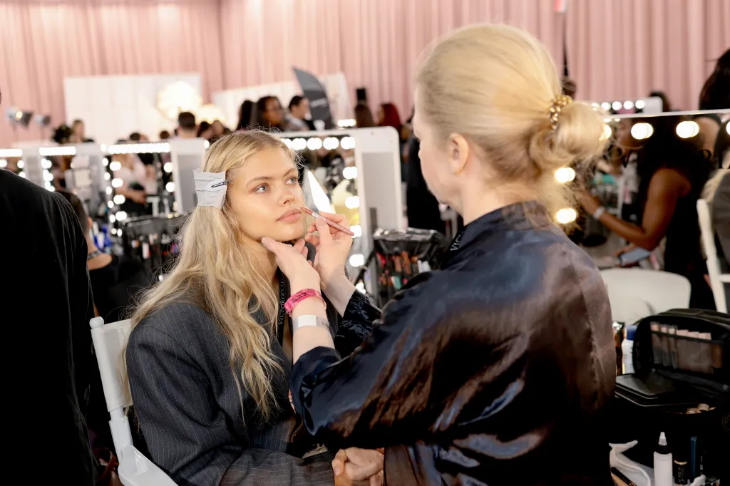 Backstage makeup preparation for a model showcase
